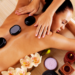 Adult woman having hot stone massage in spa salon Adult woman having hot stone massage in spa salon